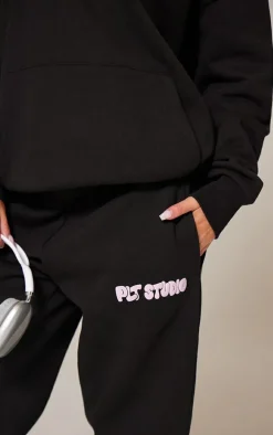 PRETTYLITTLETHING Black Premium Studio Print Cuffed Sweatpants