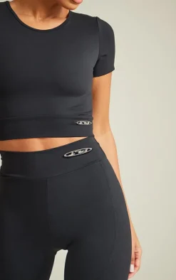PRETTYLITTLETHING Black Sport Metal Badge Sculpt Short Sleeve Crop Top